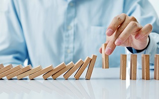 Guy playing with wooden dominoes